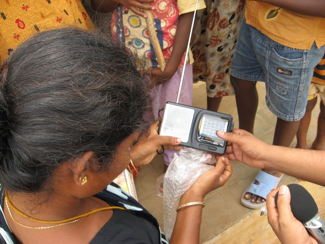 Feba India radio producer gives a radio to an interviewee
