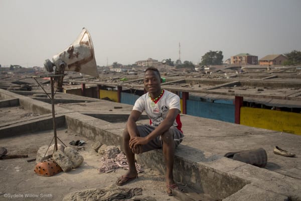 Young reporter Samuel Mutshiri on the rooof of the Gambela market (©Sydelle Willow Smith)
