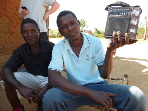 Members of the Juse community listener group with their radio