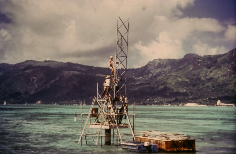 A film photograph of a radio mast being built in the middle of the ocean in the Seychelles for Feba's radio station in the 1960's.