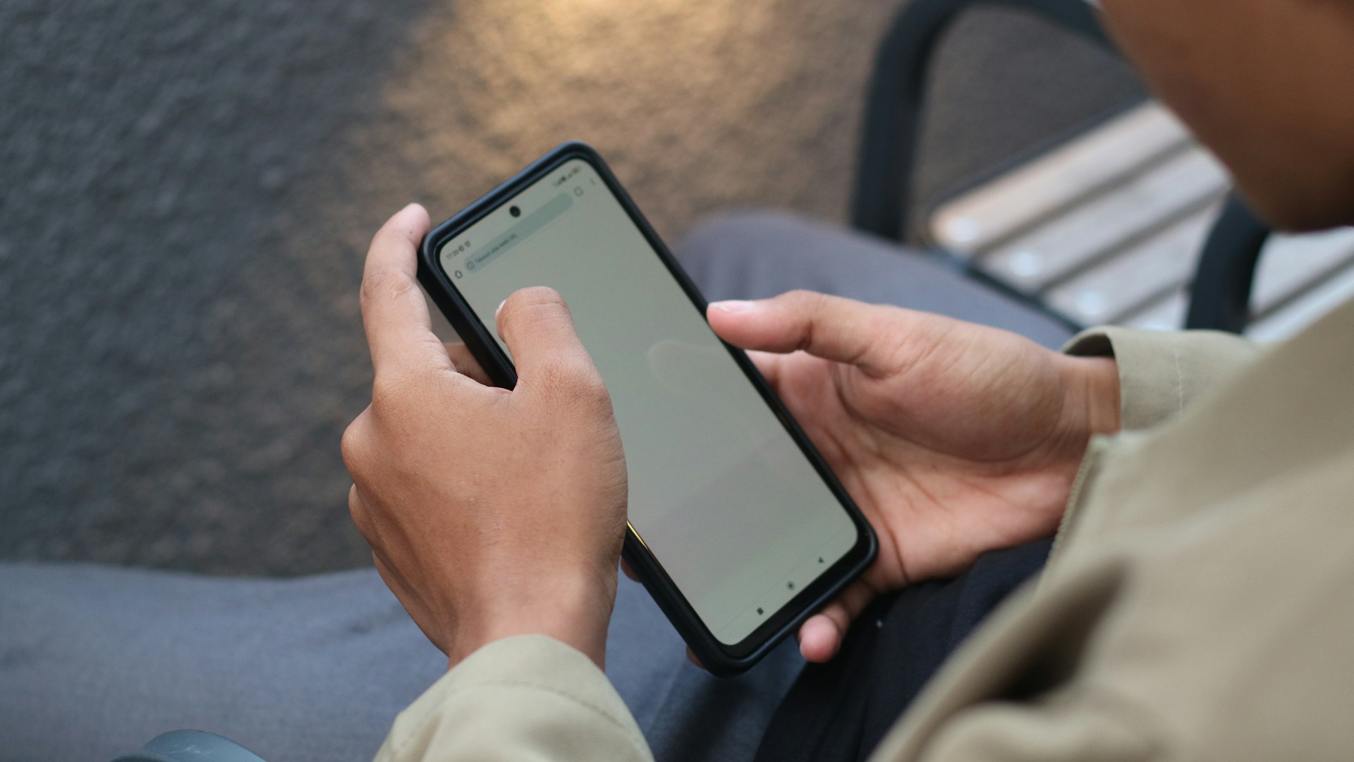 Close up a man's hands holding phone with a blank screen.