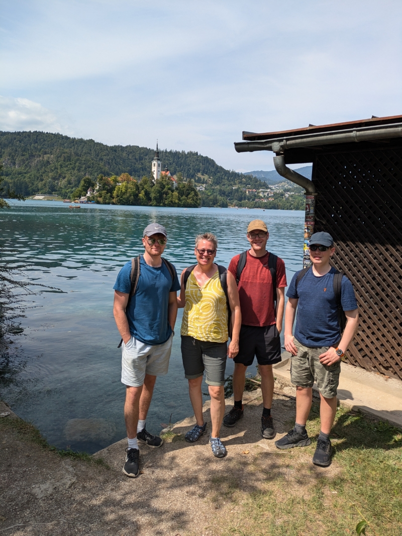Feba staff member, Esther, with her three adult sons standing on the edge of Lake Bled in Slovenia.