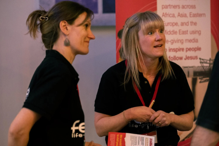 Feba staff members Emily and Ruth chatting with an attendee at the Church Sound and Media Summit.