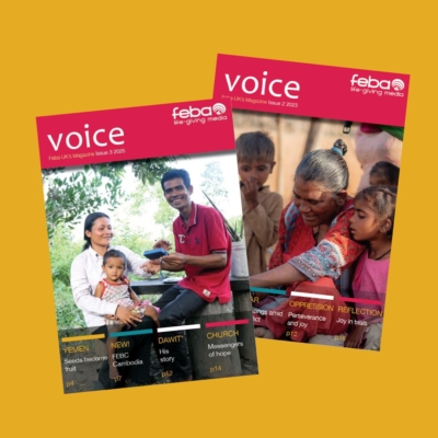Two issues of voice magazine on a yellow background.