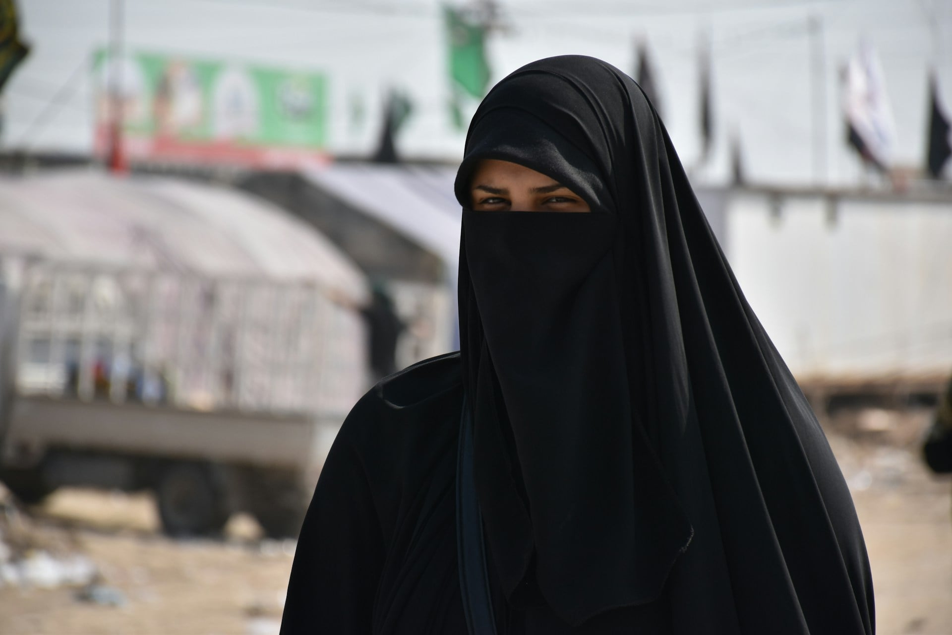 A woman in a black niqab covering.
